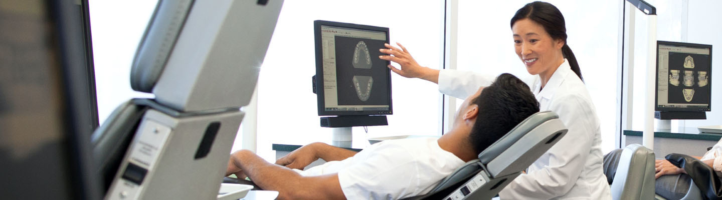 A dentist reviews X-rays with patient